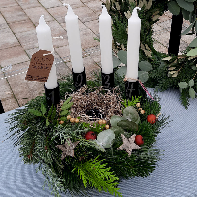 Kleiner Adventskranz mit vier Stabkerzen, wird aus Tanne und Thuja gebunden und nach Wunsch beschriftet und dekoriert. 